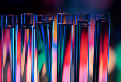Close-up on medical lab tools showing neon color reflections (source: Getty Images/iStockphoto)