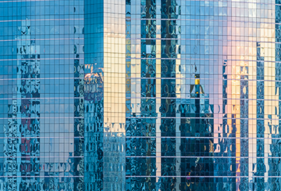 Mirror windows reflecting a skyline at sunset (source: Getty Images)