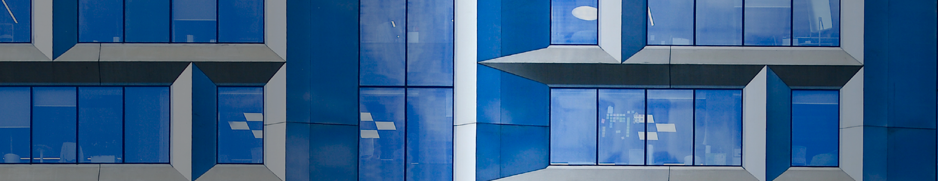 Facade of modern, glass building (source: Getty Images)