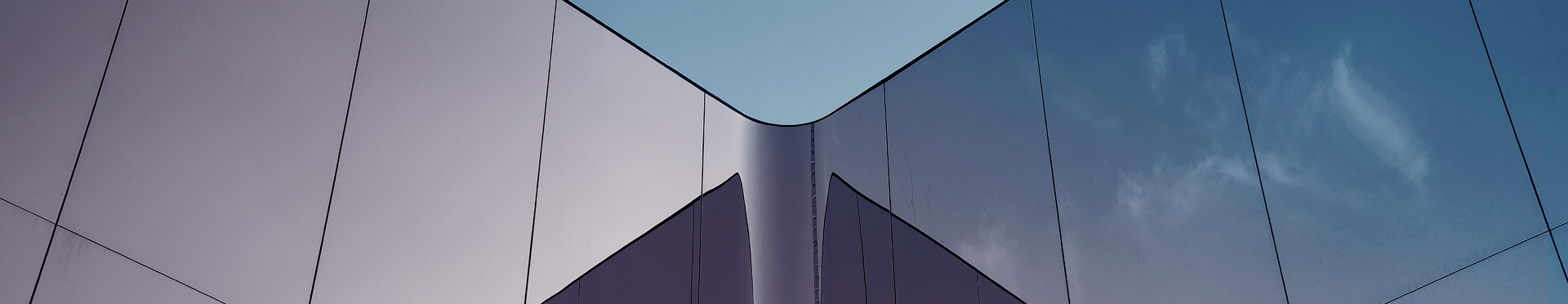Angled view of a modern, glass building (source: Getty Images)