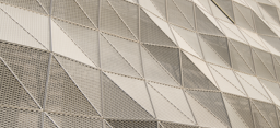Photo of a white, wavy, metal mesh design on the side of building (source: Getty Images)