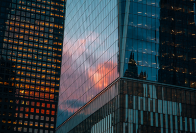 Low angle view of modern, glass buildings against the sky at sunset (credit: Getty)